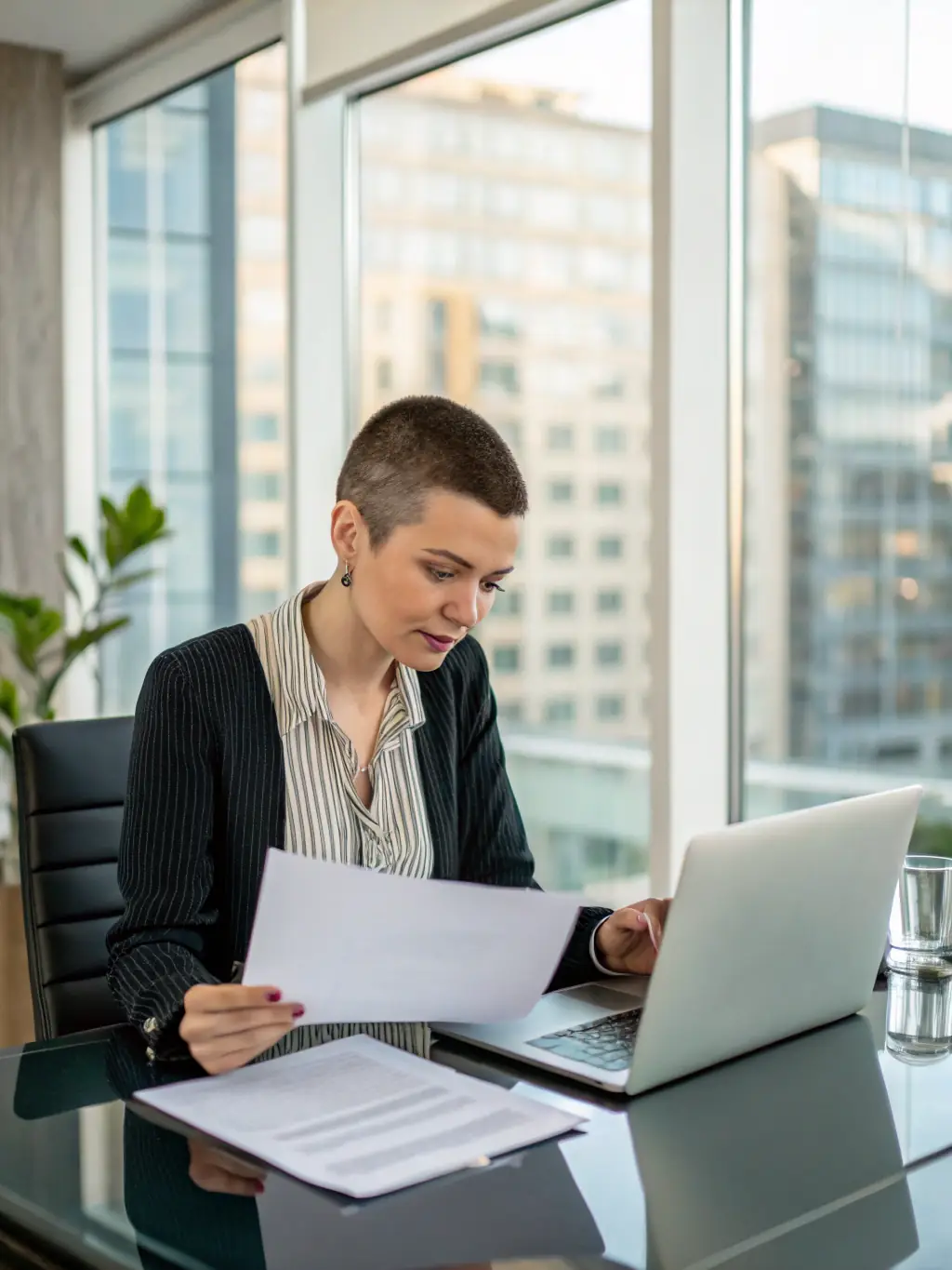 A business owner reviewing financial documents in a modern office, representing Credit Go Finance's business loan offerings.